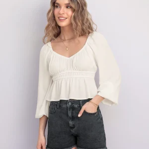 Blusa manga larga con elástico en escote